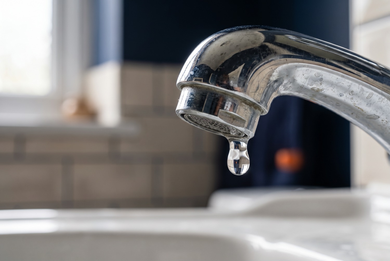 A dripping chrome tap with limescale — the kind of leak The Tap Doctor fixes